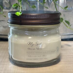 Ocean Moss soy candle in clear glass jar with wood wick, minimalist label
