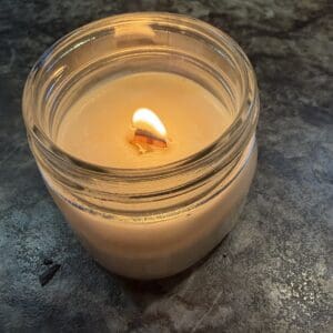 Garden Prayer handmade soy candle with wood wick burning softly