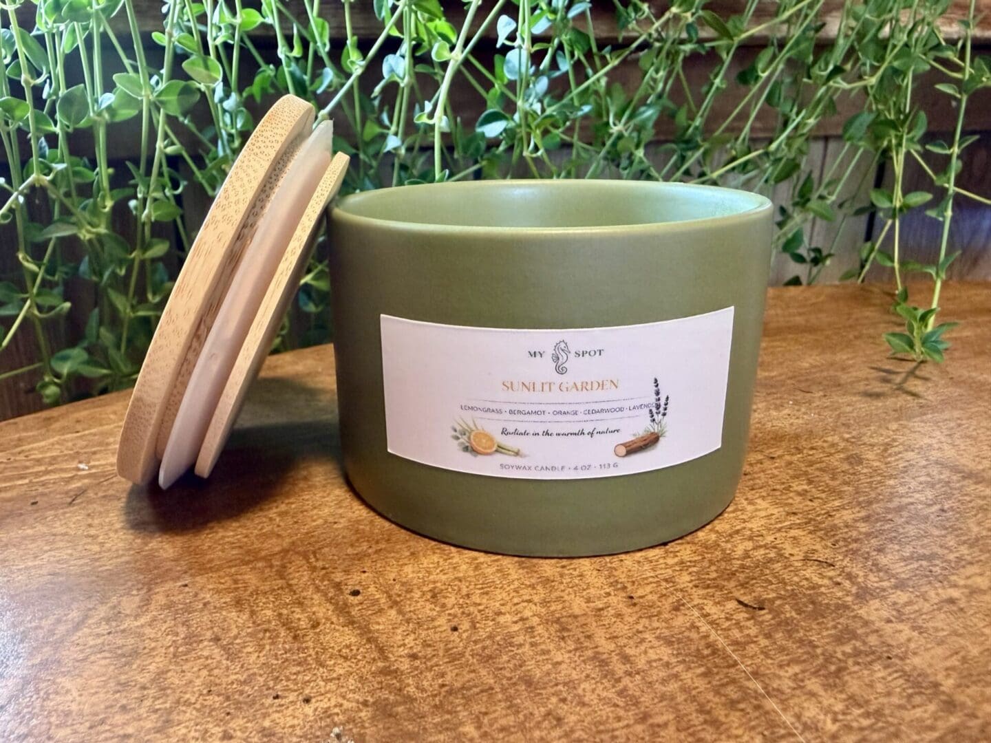 Sunlit Garden candle with bamboo lid and olive green vessel